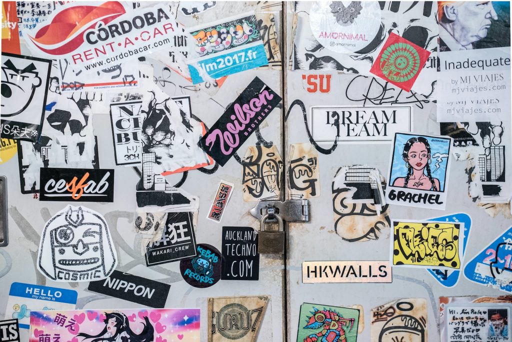 assorted stickers on white wall