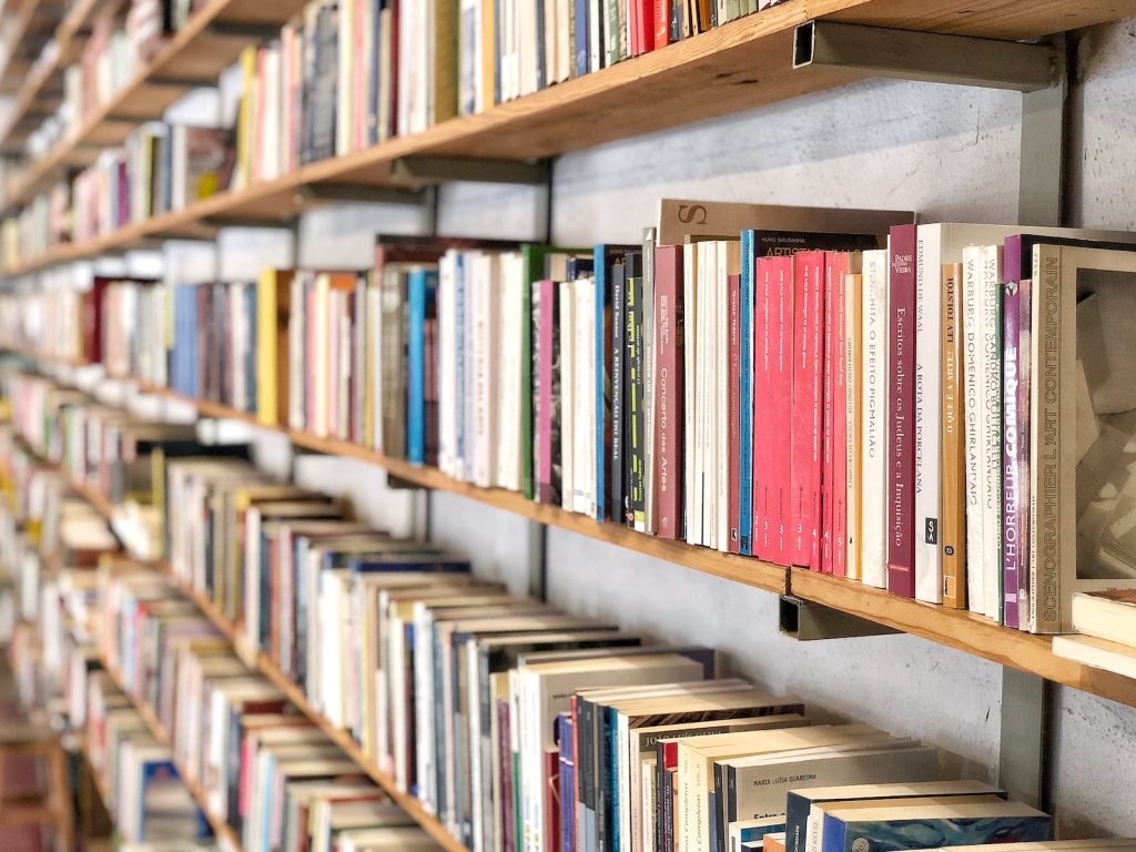 books on brown wooden shelf